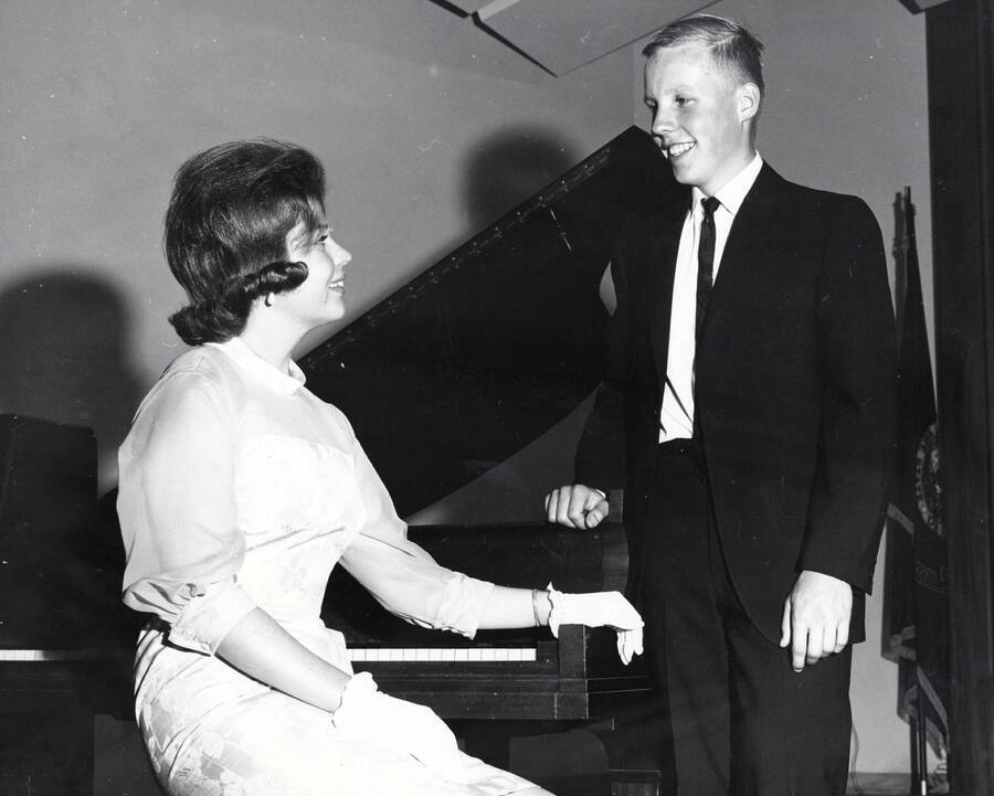 1960 photograph of Music Department. Music students in front of a piano. Donor: Publications Dept. [PG1_222-051]