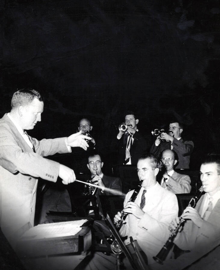 1951 photograph of Music Department. Paul Yoder conducting an outdoor summer band concert at night. Donor: Publications Dept. [PG1_222-061]