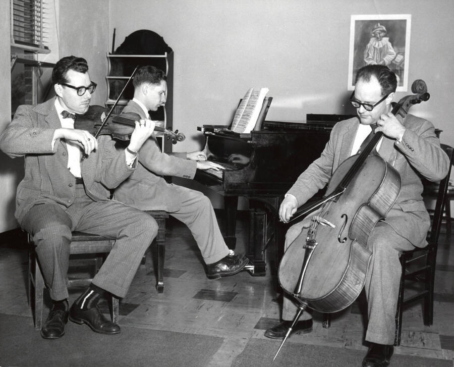 1952 photograph of Music Department. Music facultry trio LeRoy Bauer, David Whisner, and an unidentified man rehearsing. Donor: Publications Dept. [PG1_222-070]