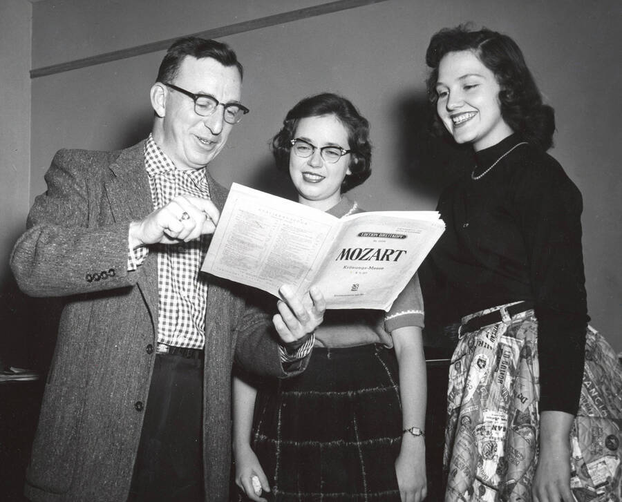 1957 photograph of Music Department. Glen Lockery, Marigay Nelson, and an inidentified student study sheet music. Donor: Publications Dept. [PG1_222-071]
