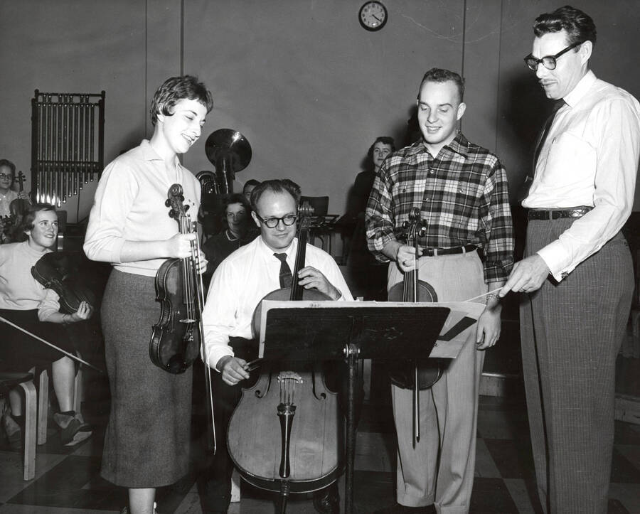 1951 photograph of Music Department. Music students with cellist David Whisner and conductor LeRoy Bauer during rehearsal. [PG1_222-073]