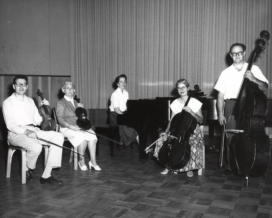 1952 photograph of Music Department. Piano quintet LeRoy bauer, unidentified, Marian Frykman, David Whisner, and an unidentified man on stage. Donor: Publications Dept. [PG1_222-075]
