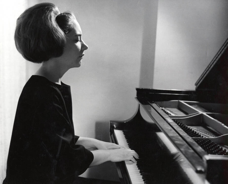 1963 photograph of Music Department. Paula Tyler playing a piano. Donor: Publications Dept. [PG1_222-079]