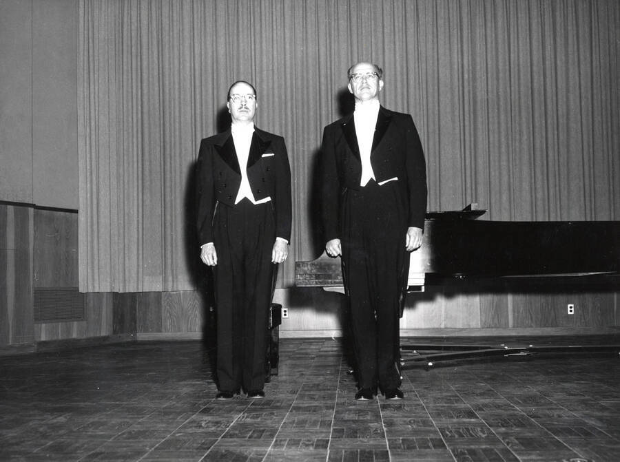 1962 photograph of Music Department. Hall Macklin and Norman R. Logan on stage in front of a piano. [PG1_222-081]