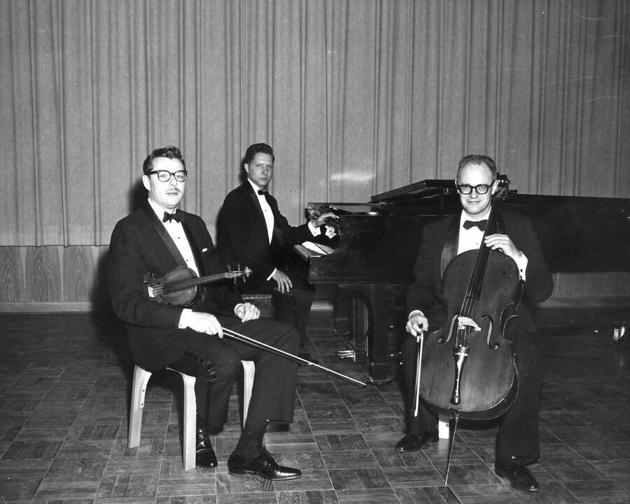1962 photograph of Music Department. LeRoy Bauer, Steven Romanio, and David Whisner on stage ready to perform. [PG1_222-082]