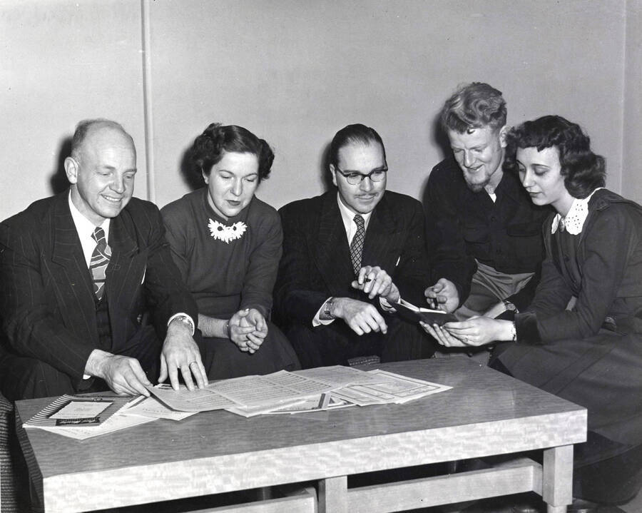 1962-01-03 photograph of Music Department. Elwyn Schwartz, Marion Frykman, Hall Macklin, Rex Eikum, Bonne Allee confer about All American Composers Concert [PG1_222-083]