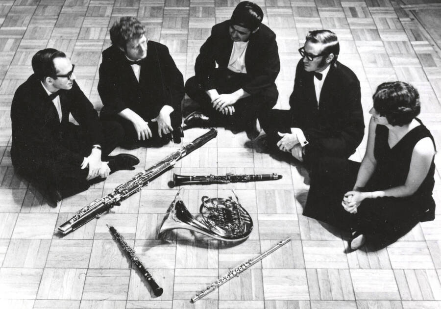 1964 photograph of Music Department. Northwest Wind Quartet sitting with their instruments. [PG1_222-088]