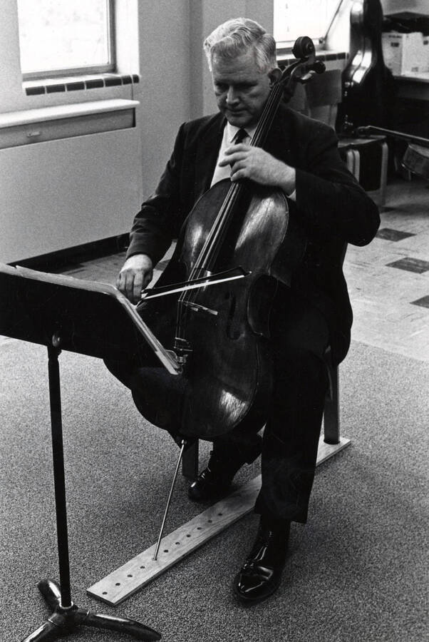 1970 photograph of Music Department. W. Howard Jones playing a cello. [PG1_222-093]