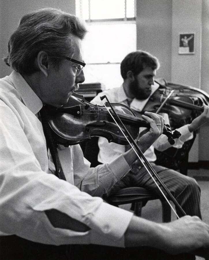 1970 photograph of Music Department. LeRoy Bauer and Brice Farrar play the violin. [PG1_222-095]