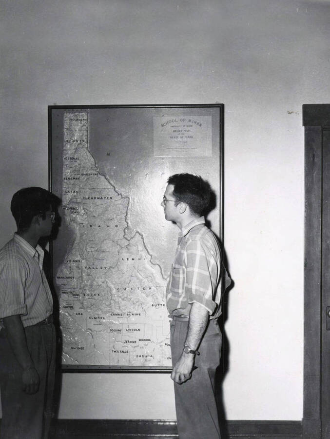 1953 photograph of College of Mines. Students study a relief map of Idaho. [PG1_223-12]