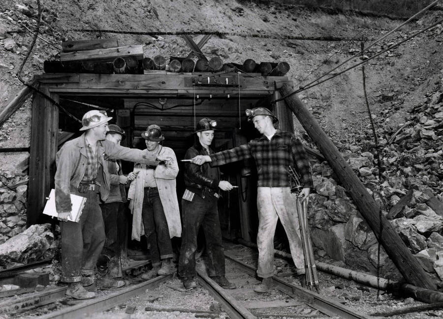 1953 photograph of College of Mines. Students outside a mine during an exhibit. [PG1_223-15]