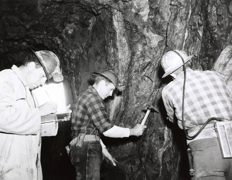 1953 photograph of College of Mines. Students examining a tunnel wall inside a mine. [PG1_223-21]