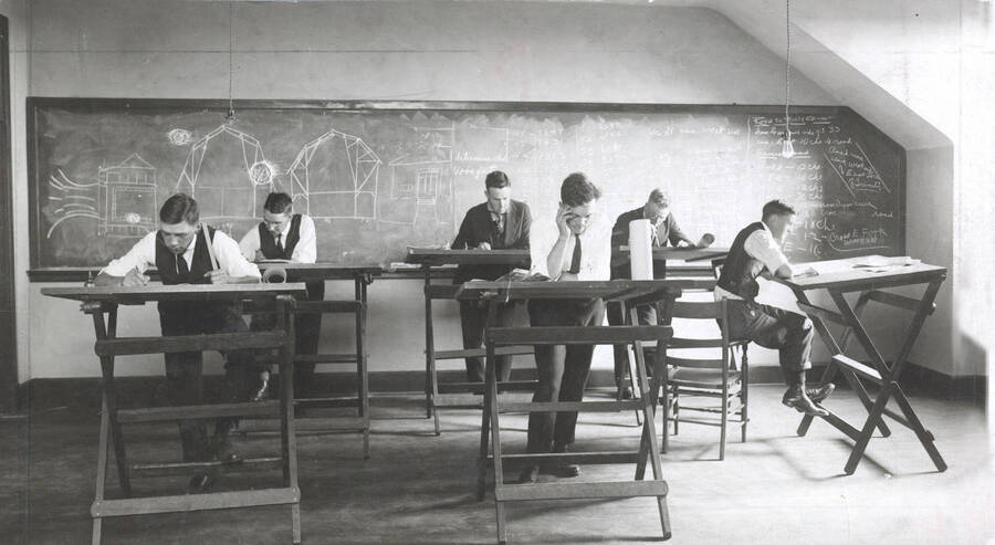 1926 photograph of College of Engineering. Students drawing at drafting desks during class. [PG1_224-26]