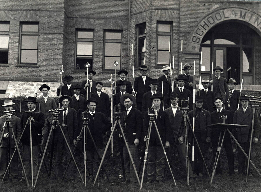 1907 photograph of College of Engineering. Students with surveying equipment in front of the School of Mines building. [PG1_224-29]