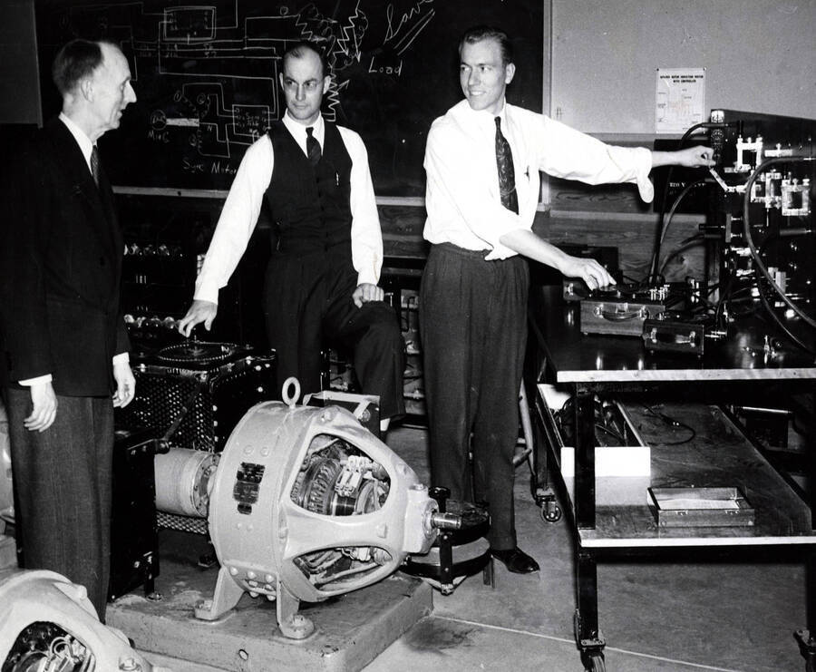 1942 photograph of College of Engineering. J. Hugo Johnson, Keith Freeman, and David C. Stevens in the elctrical engineering laboratory. [PG1_224-30]