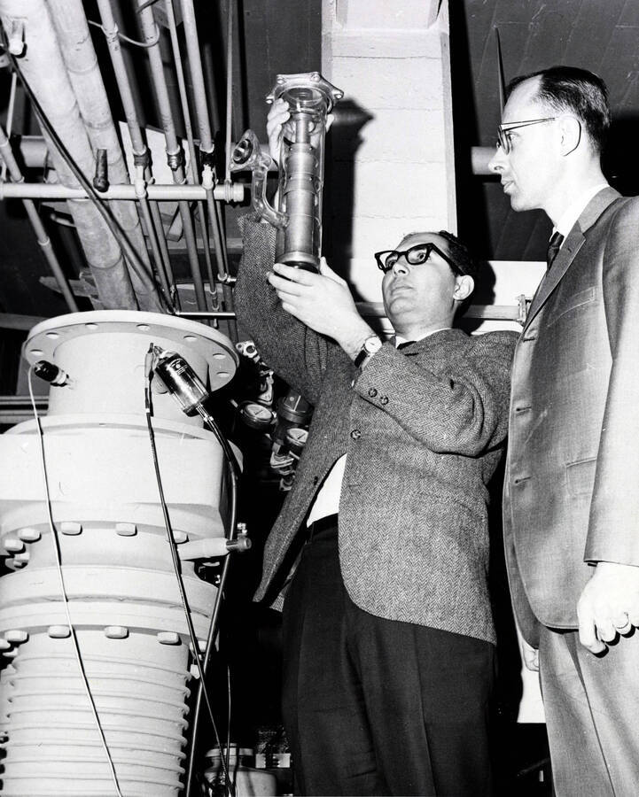 College of Engineering. University of Idaho. Dr. Jacob B. Romero and Dr. Robert R. Ferguson compare diffusion pumps. [224-36]