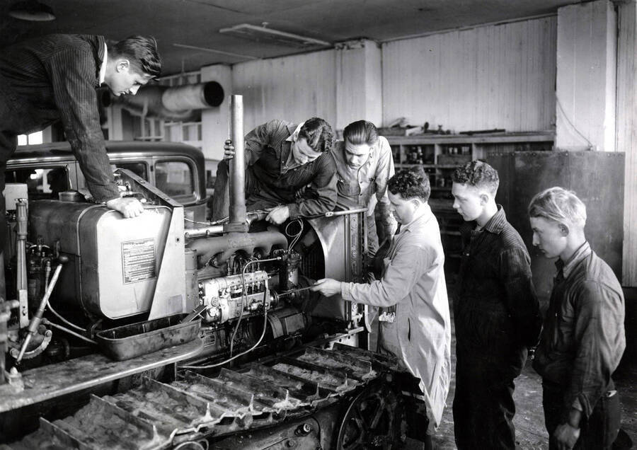 1935 photograph of College of Engineering. Students working on an engine during the motor mechanics course. Donor: Publications Dept. [PG1_224-40]