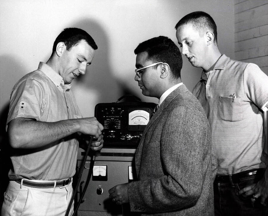 1966 photograph of College of Engineering. James Okeson, David D. Powers, and Godfrey Q. Martin checking a hot film anemometer. [PG1_224-44b]