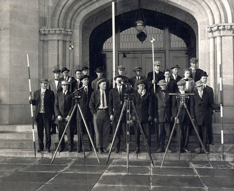 1911 photograph of College of Engineering. Students with survery equipment on the steps of the Administration building. Students are labeled 1. V. Samms 2. S. Regan 3. W. Scott 4. B. Kinnison 5. T. Doyle 6. W. Murray 7. G. Scott 8. D.B. Steinmann 9. A. Cooper 10. R. Tuttle 11. H.B. Soulen 12 C. Lewis 13. V. Fawcett 14 B. Wookridge 15. R. Perkins. Donor: From Dean Janssen's papers. [PG1_224-60]