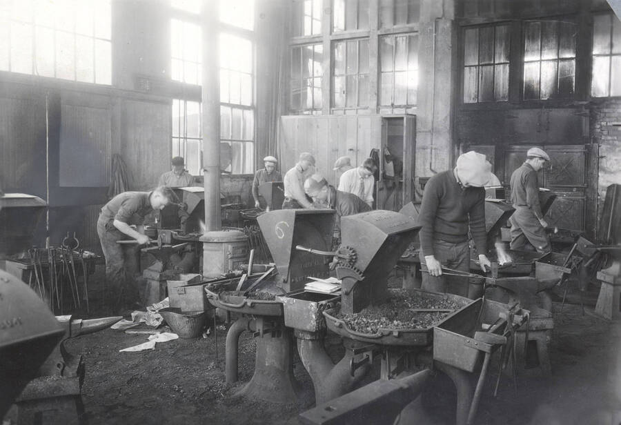 1922 photograph of College of Engineering. Students working in the forge shop. [PG1_224-09]