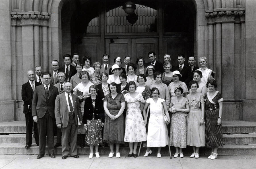 1933 photograph of College of Education. County superintendent's short course attendees stnading on the Administration building's steps. [PG1_227-01]