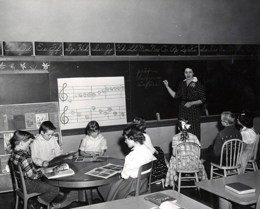 1953 photograph of College of Education. A student teacher instructs a classroom. [PG1_227-05]