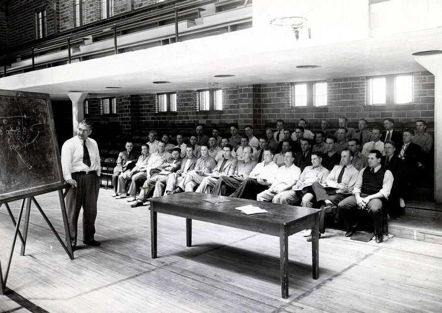 1938 photograph of Physical Education. Eric Waldorf instructing the summer coaching course. Interior of the gymnasium. [PG1_229-01]