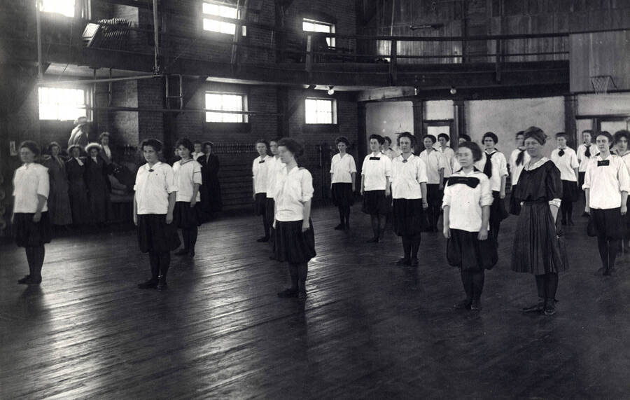 1911 photograph of Physical Education. Female students inside the gymnasium during class. [PG1_231-10]