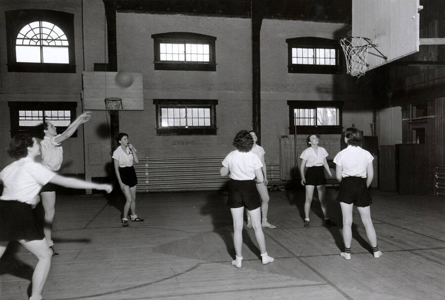 1936 photograph of Physical Education. Women's basketball in the gymnasium. [PG1_231-07]