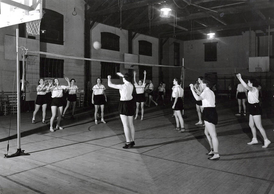 1936 photograph of Physical Education. Women's volleyball inside the gymnasium. [PG1_231-08]