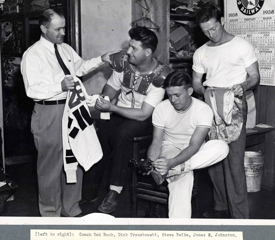1938 photograph of Athletics. l-r: Coach Ted Bank, Dick Trzuskowski, Steve Belko, James E. Johnston. [PG1_235-05]