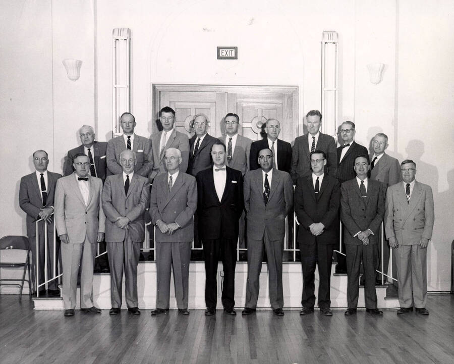 1958-04-01 photograph of Agricultural Extension Service. Conference group photograph. 18 people in the photograph are identified. First Row: J. H. Starr (Wyoming), Charles W. Smith (Oregon), C. M. Ferguson (FES), Shawnee Brown (FES), Jack Claar (FES), Al Triviz (New Mexico), C. A. Svinth (Washington), Dale GOodall (Hawaii), L. S. Kurtz (New Mexico); Back Row: N. E. Beers (Montana), Robert H. Black (New Mexico), Lee Benson (California), Carl Frischknecht (Utah), W. G. Stucky (Nevada), J. E. Morrison (Colorado), George Alcorn (California), C. O. Youngstrom (Idaho), and Howard Baker (Arizona). Donor: University of Idaho Cooperative Extension System. [PG1_237-10]