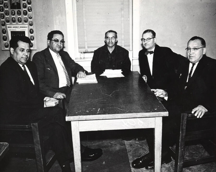 Group of Extension Service representatives meeting at Fort Hall, Idaho. Clyde Pensureau, left; Frank Parker, second from left; C.O. Youngstrom, fourth from left; Russell Pokibro, right.. [237-13a]