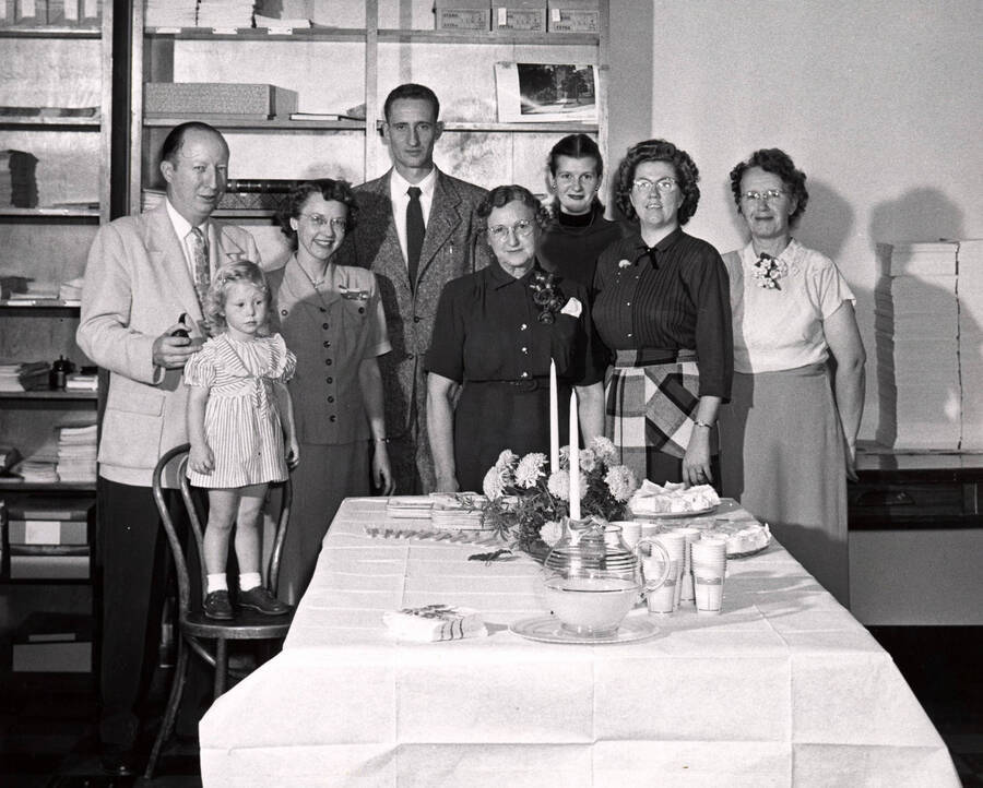 1952-09-26 photograph of Publications Department. Rafe Gibbs, Linda Gibbs, Mrs. Rafe Gibbs, Newt Cutler, Miss Hobson, Mrs. Newt Cutler, Rita Cain, and Jennie Nesbit. [PG1_238-01]
