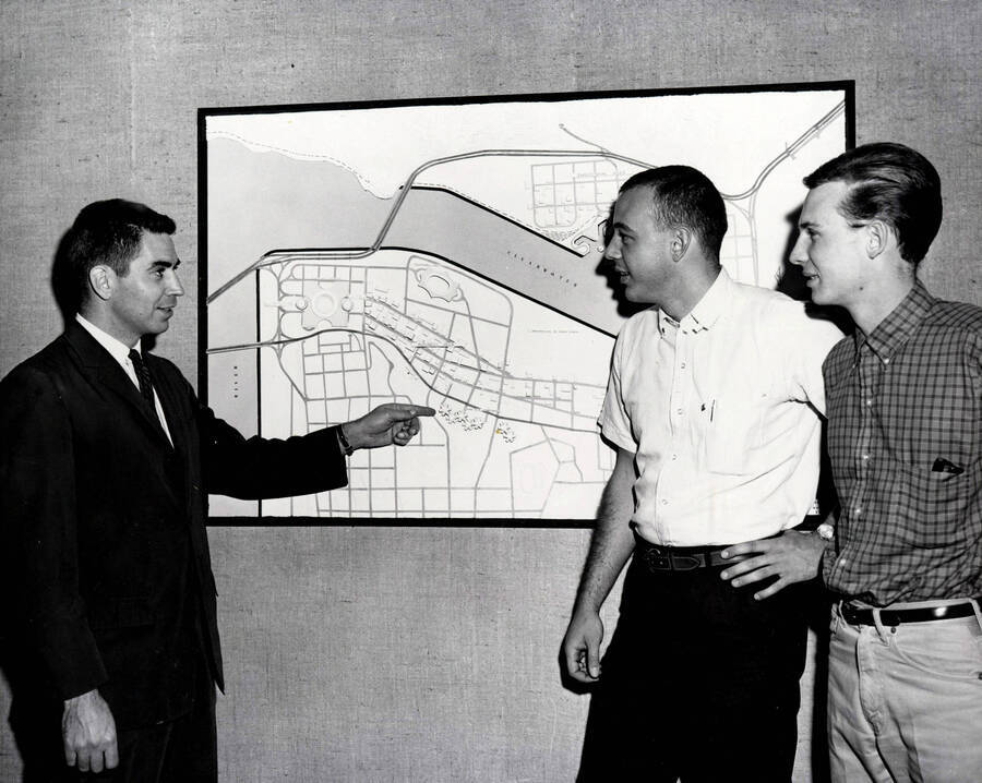 1963 photograph of Art and Architecture. Paul Blanton with students Terry Schofield and Lorenzo Nelson looking at a map. Donor: Publications Dept. [PG1_241-13]
