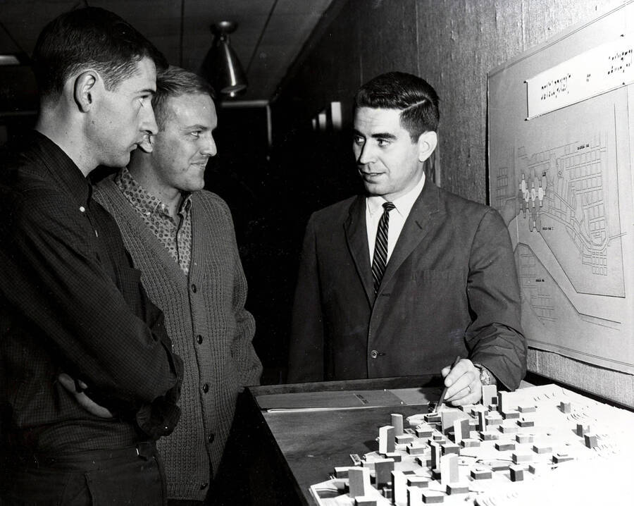 1967 photograph of Art and Architecture. Paul Blanton and students standing around a small model of a map. Donor: Publications Dept. [PG1_241-17]