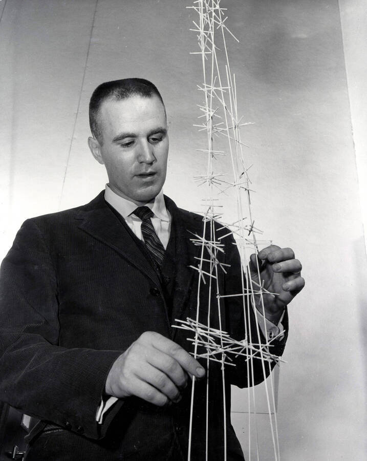 1961 photograph of Art and Architecture. Iain Baxter assembling a sculpture. Donor: Publications Dept. [PG1_241-21a]