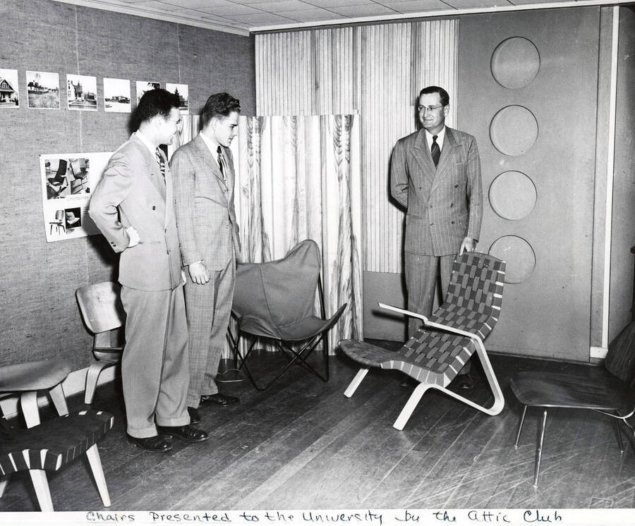 Art and Architecture. University of Idaho. President J. E. Buchanan viewing chairs presented by Attic Club. [241-31]