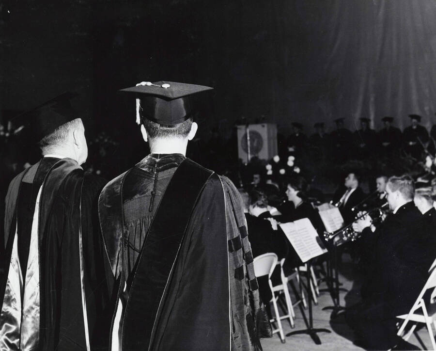 1964 photograph of 75th Anniversary. Symphonic Band performing in academic regalia during the 75th anniversary Convocation. [PG1_246-03]