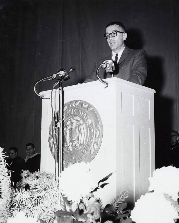 1964 photograph of 75th Anniversary. ASUI president William Frates Witherspoon at lectern during the convocation. [PG1_246-09]