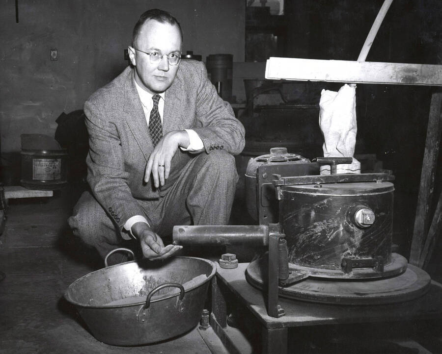 1956 photograph of Geology. Dr. Earl F. Cook with equipment. Donor: Publications Dept. [PG1_250-02]