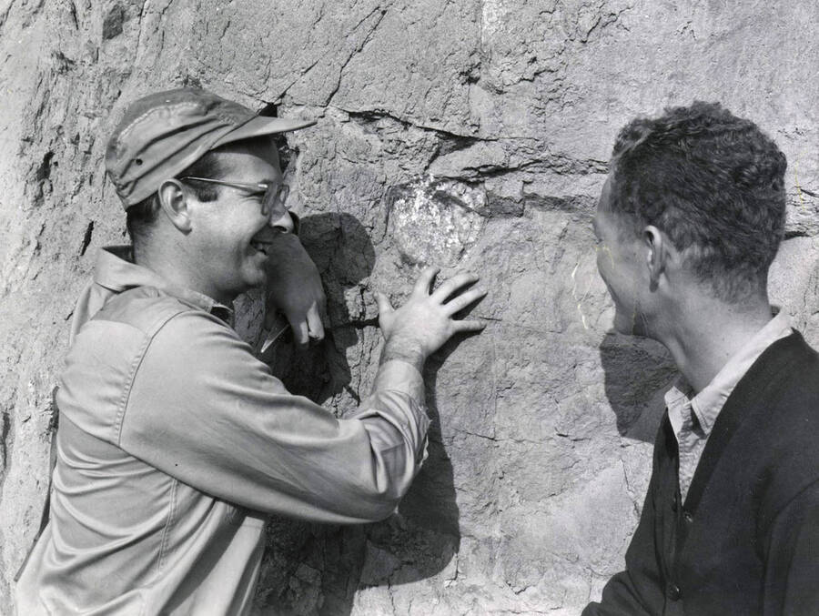 Geology. University of Idaho. Prof. McDivitt and Roger Lillibridge study rock outcropping near Kellogg. [250-3]