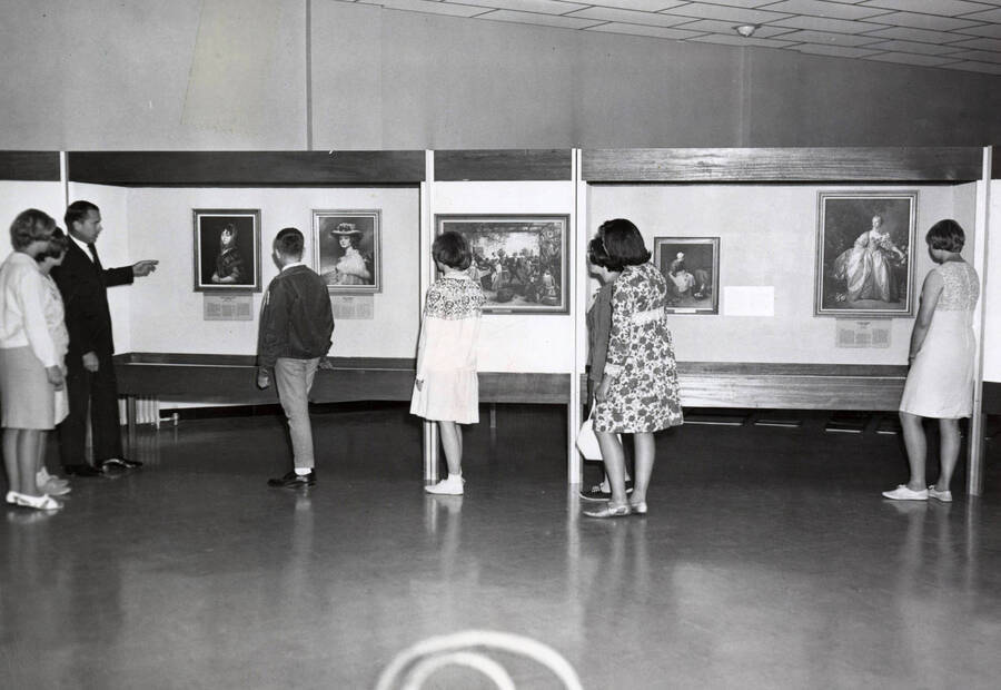 1966 photograph of Museum. G. Ellis Burcaw gives tour of art exhibit to visiting 4-H club members. [PG1_251-04]