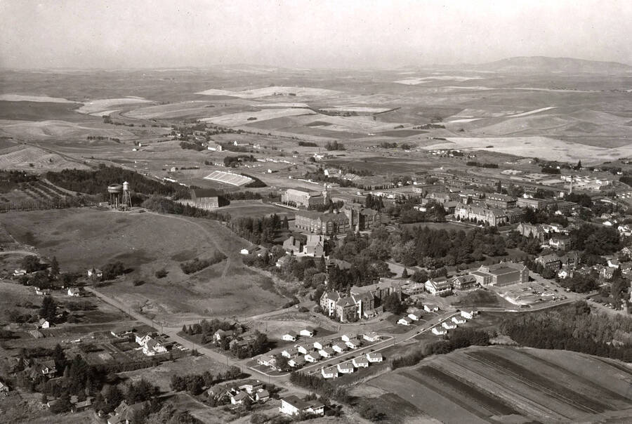 1954 photograph of University of Idaho campus. Aerial view shows both water towers on campus. Donor: Publications Dept. [PG1_003-13]