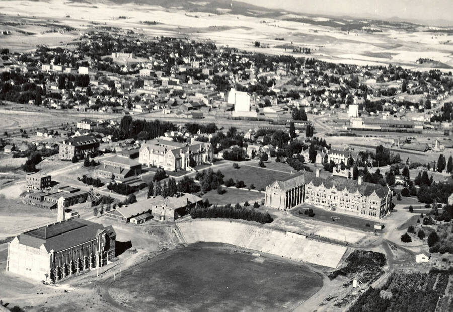 1932 photograph of University of Idaho campus. Aerial view shows both campus and Moscow looking northeast. [PG1_003-02]