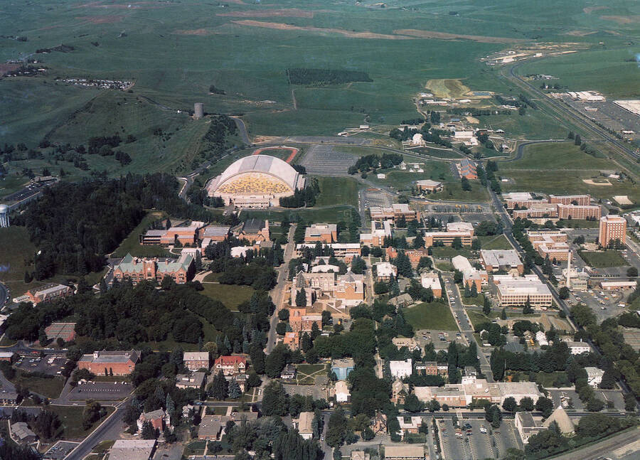 1985 photograph of University of Idaho campus. A color aerial view shows campus with Kibbie Dome. [PG1_003-46]