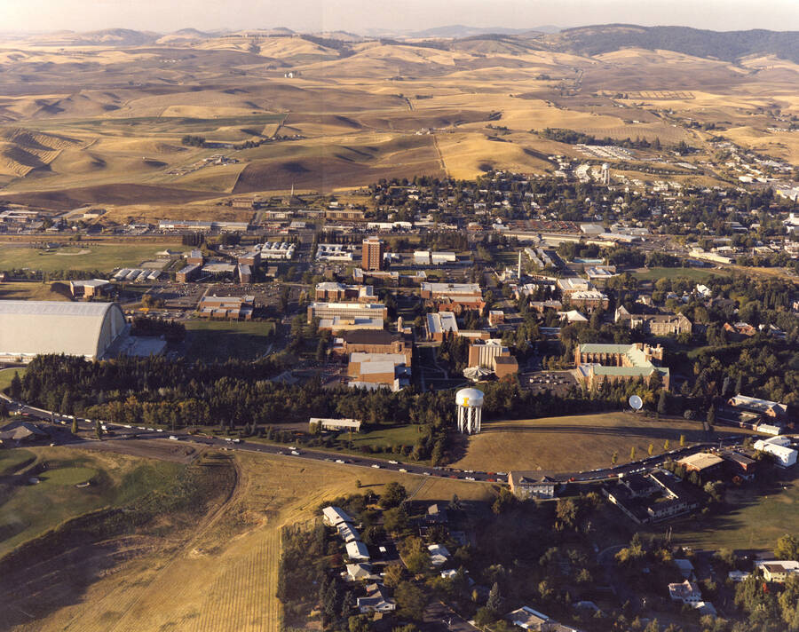 1960 photograph of University of Idaho campus. A color aerial view shows both campus and surrounding farm fields. [PG1_003-49]