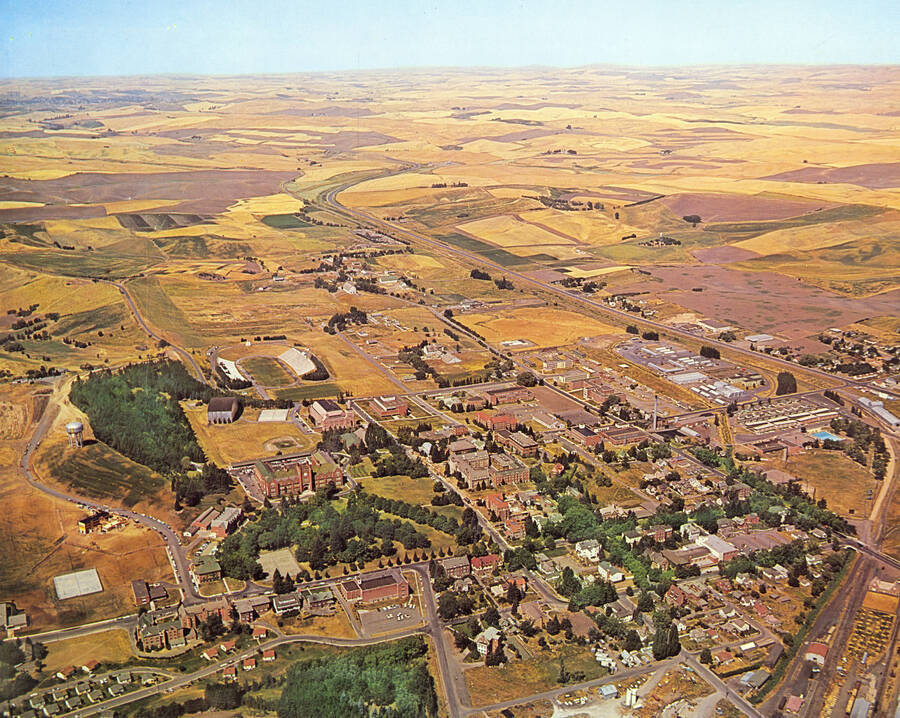 1960 photograph of University of Idaho campus. A color aerial view shows surrounding farm fields. [PG1_003-09]