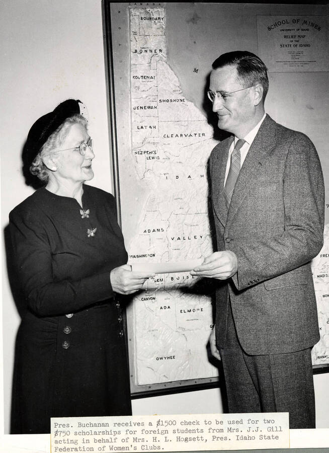 1947 photograph of Gifts. Mrs. J. J. Gill presents a check to President Buchanan. Donor: Publications Dept. [PG1_400-16]
