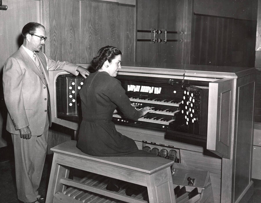 1953 photograph of Gifts. Hall Macklin and Marian Frykman at an organ. Donor: Publications Dept. [PG1_400-21]